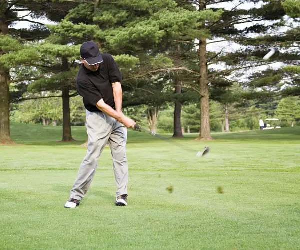 Golfer hitting hybrid club