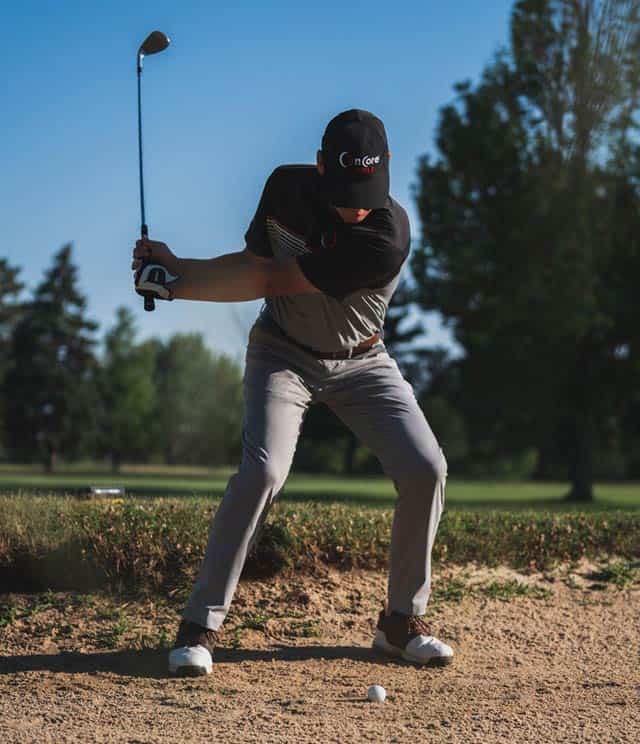 Golfer hitting from bunker